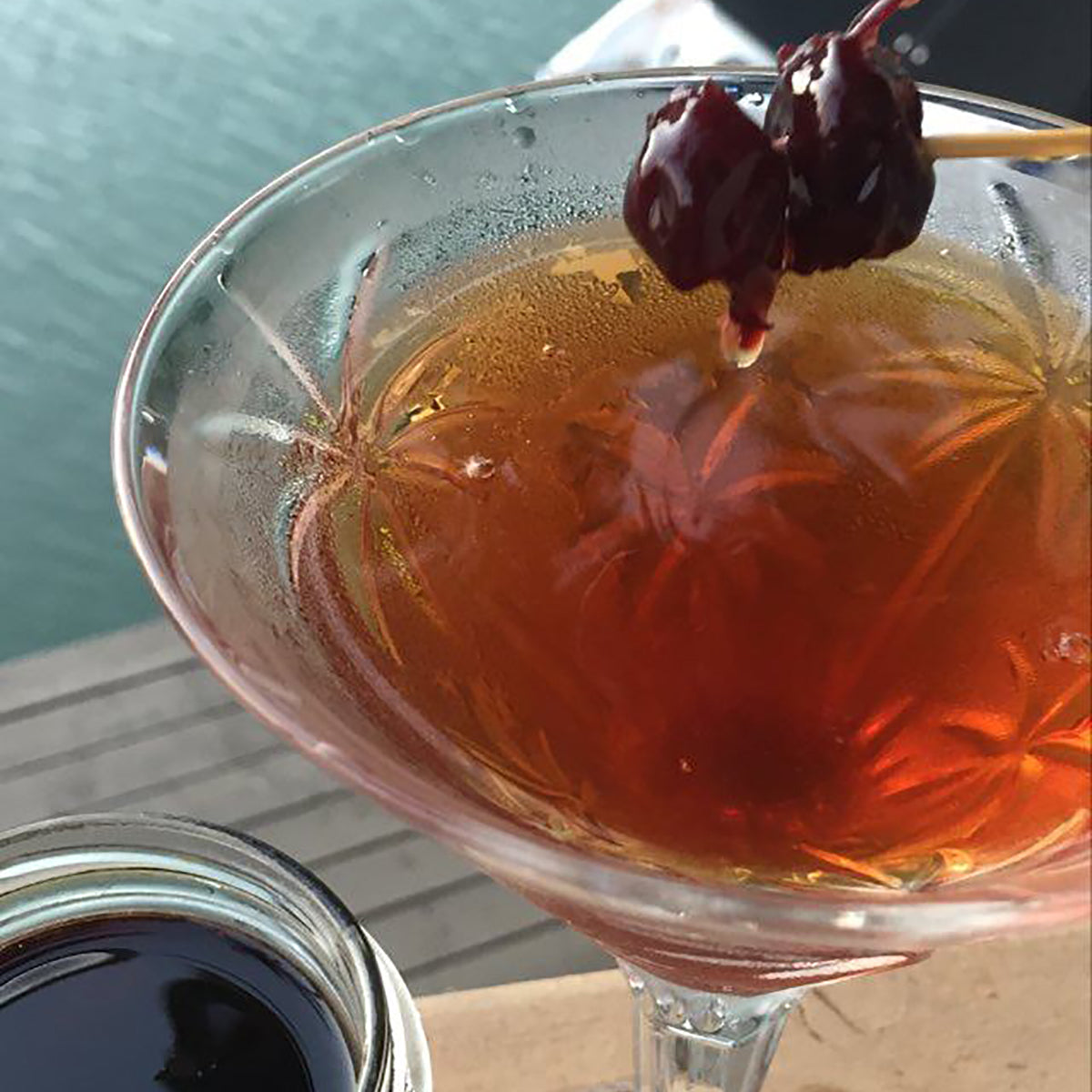 Manhattan cocktail with citrus chios sour cherry fruit preserved in syrup