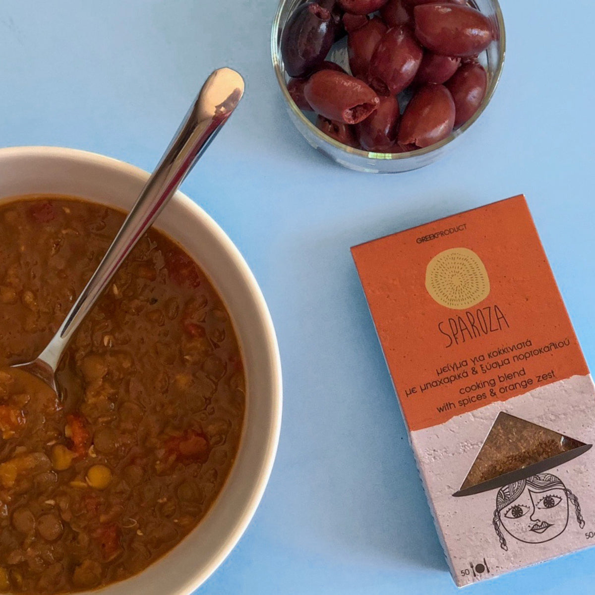 Bowl of lentil soup with olives and Sparoza's cooking blend with spices and orange zest